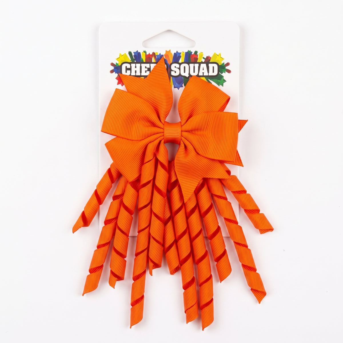 Orange grosgrain korker hair bow with spiral ribbon tails on card