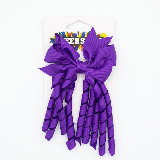 Purple grosgrain korker hair bow with spiral ribbon tails on card