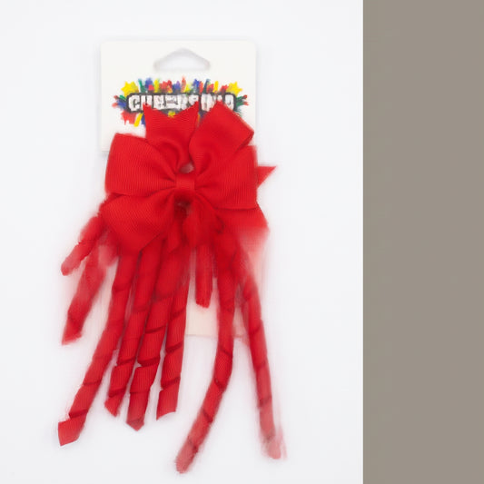 Red grosgrain korker hair bow with spiral ribbon tails on card