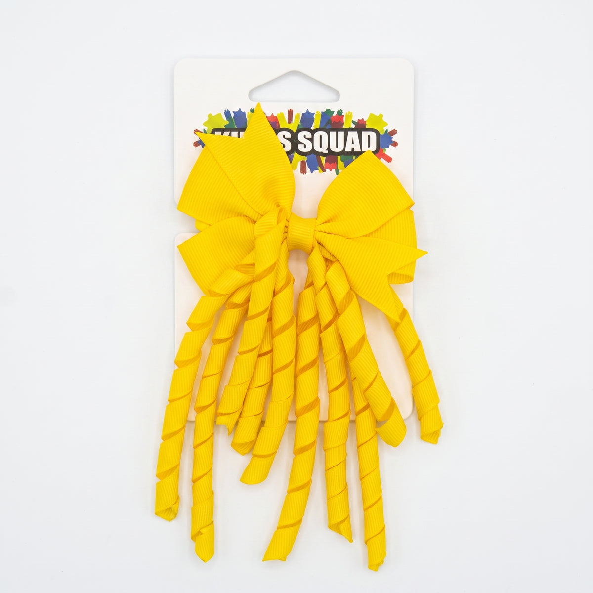 Yellow grosgrain korker hair bow with spiral ribbon tails on card